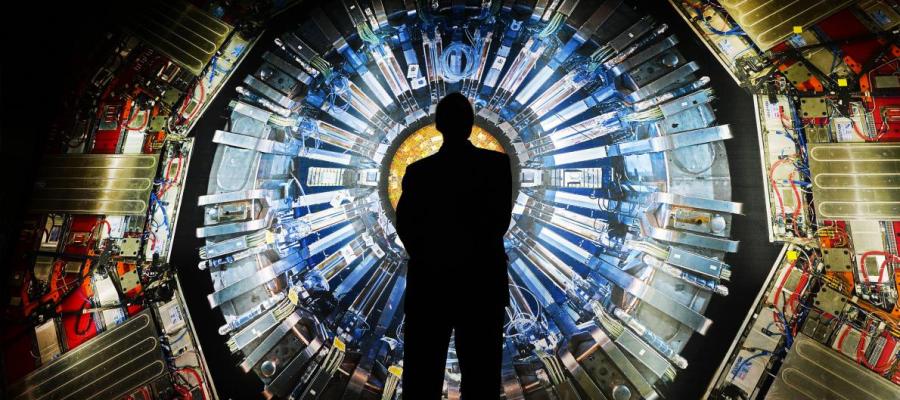 Person Standing In Front of Particle Accelerator