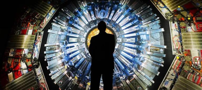Person Standing In Front of Particle Accelerator